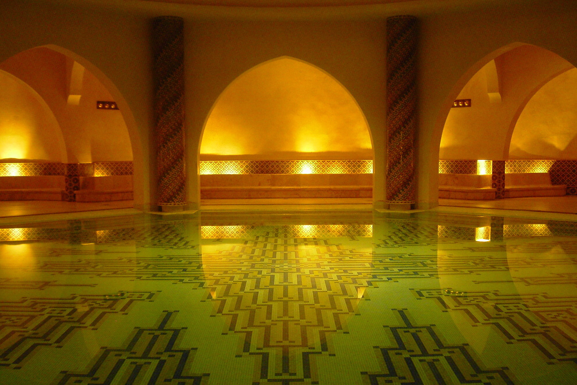 Indoor swimming pool with dimmed lights providing a cozy atmosphere