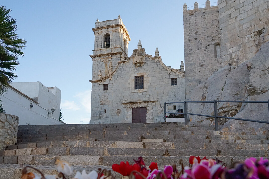 Ermitana Church on top of a hill with flowers in front of it