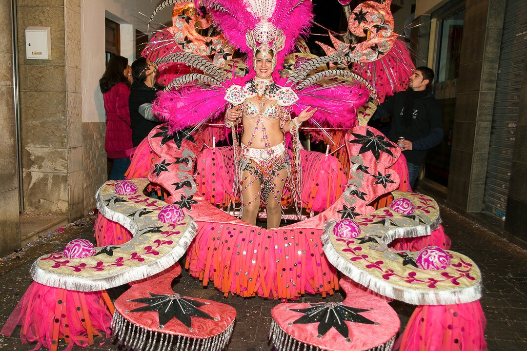 Woman in an opulent pink carnival costume in Sitges, Spain