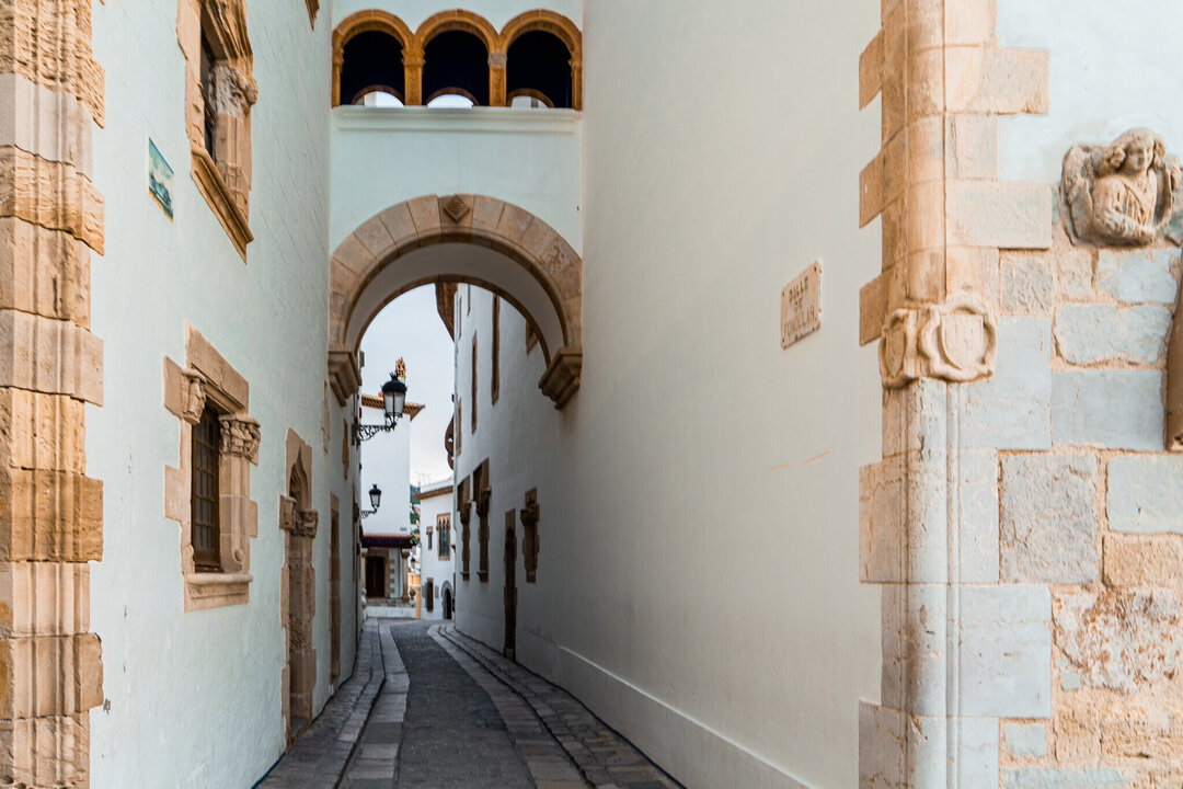 White narrow street in the old town of Sitges, Spain.