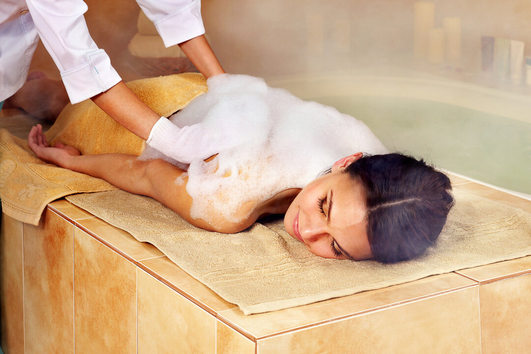Woman enjoying a hammam spa treatment with massage