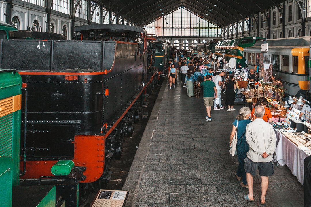 People having a pleasant day between old locomotives and craft stalls at the Motor Market in Madrid, Spain.