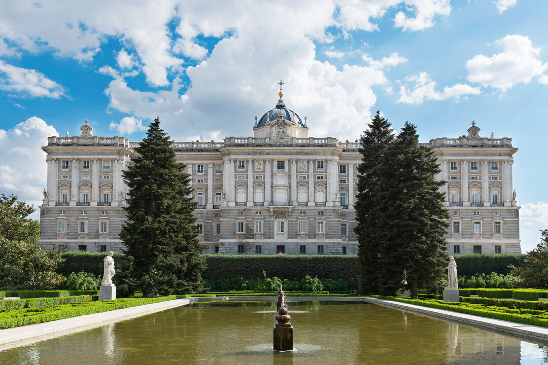 Royal Palace with Gardens in beautiful gardens and a blue sky in the background in Madrid, Spain.