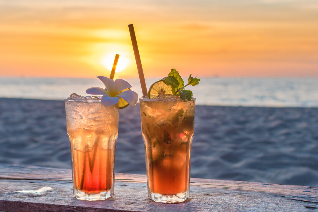 Drinks at the beach with sunset background in Spain.